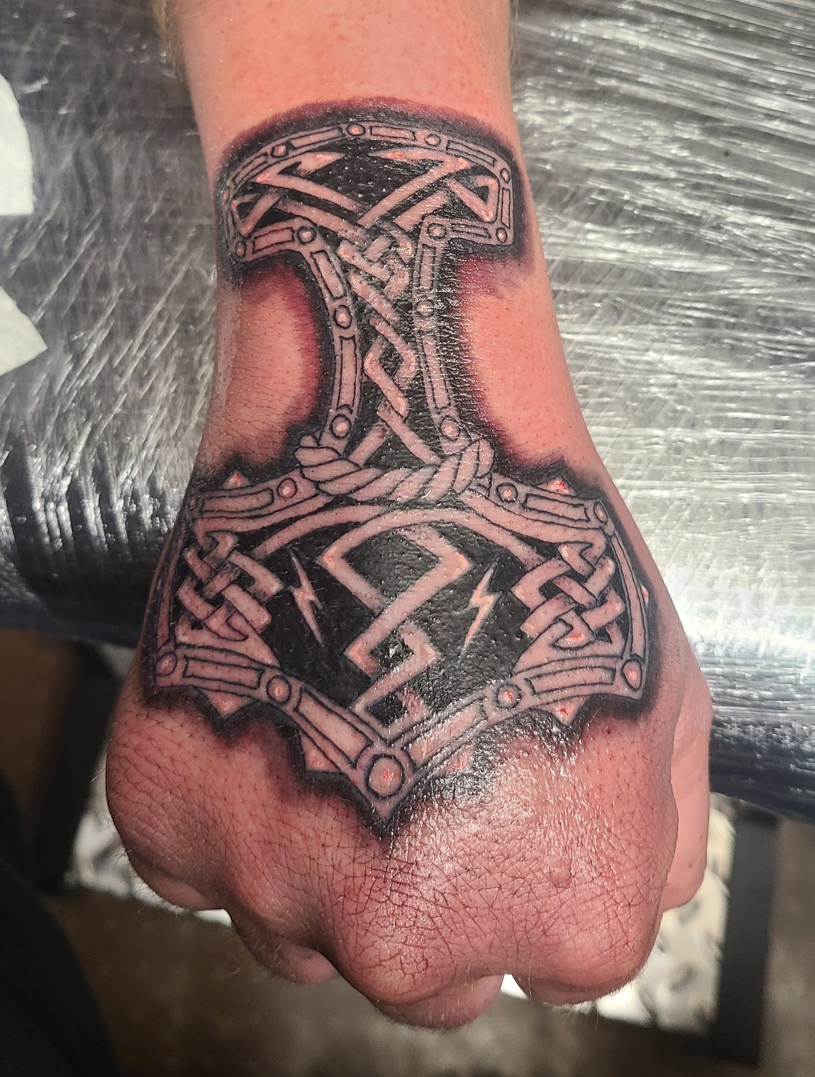 Black and grey hand tattoo with geometric detail by Social Suicide Tattoos in Pahrump, Nevada