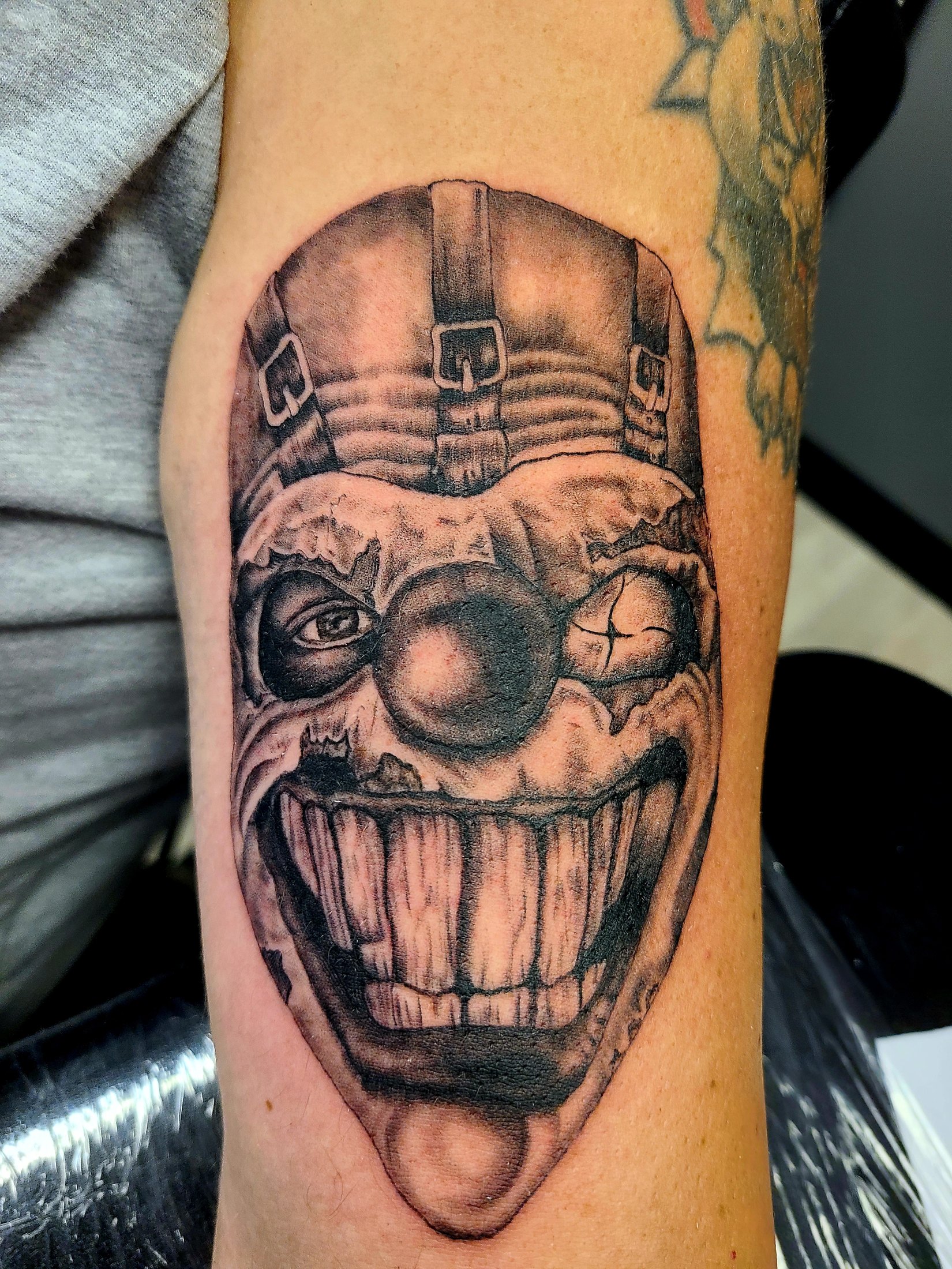 Black and grey clown mask tattoo by Social Suicide Tattoos in Pahrump, Nevada