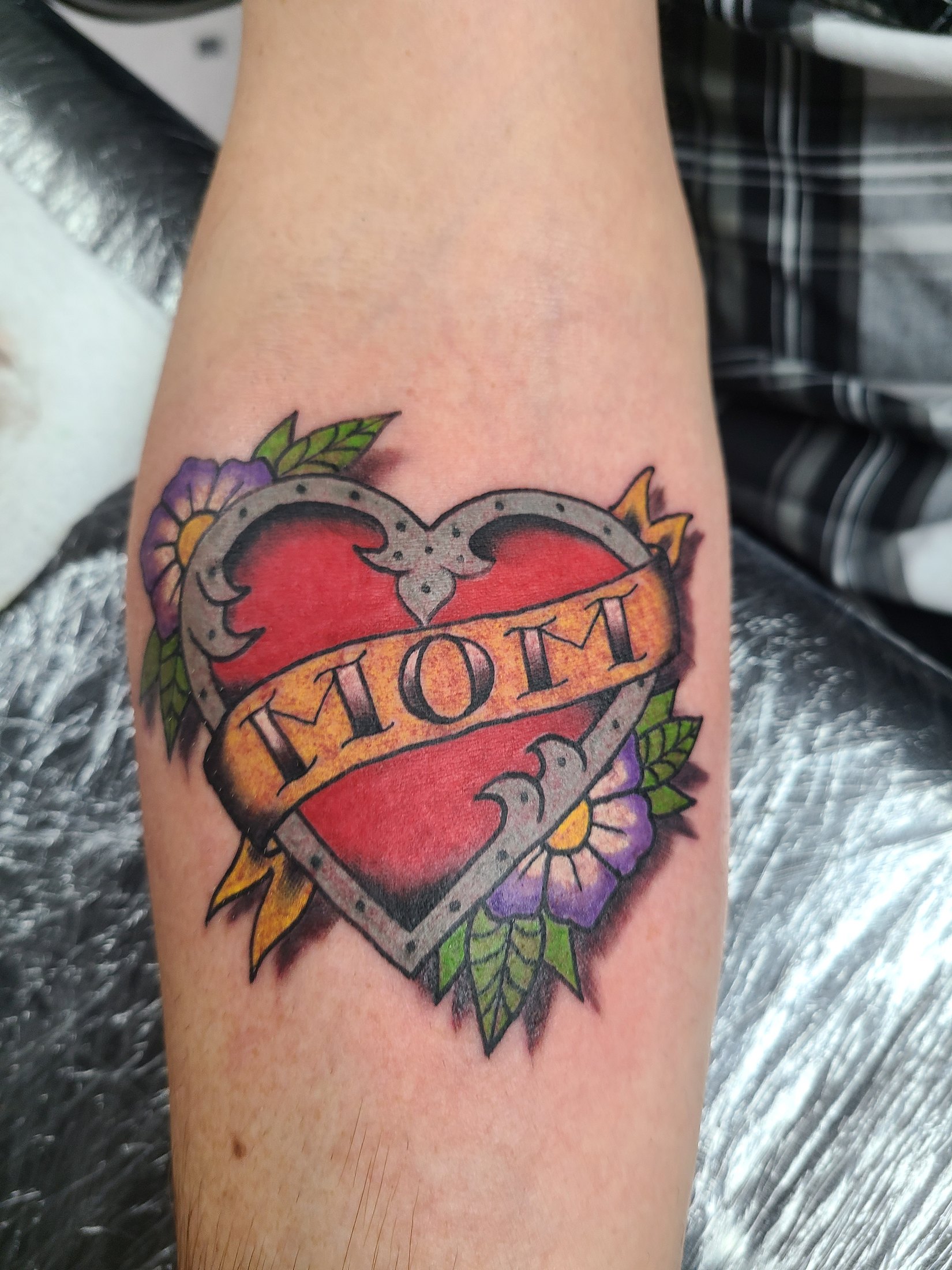Color shield and flowers tattoo by Social Suicide Tattoos in Pahrump, Nevada