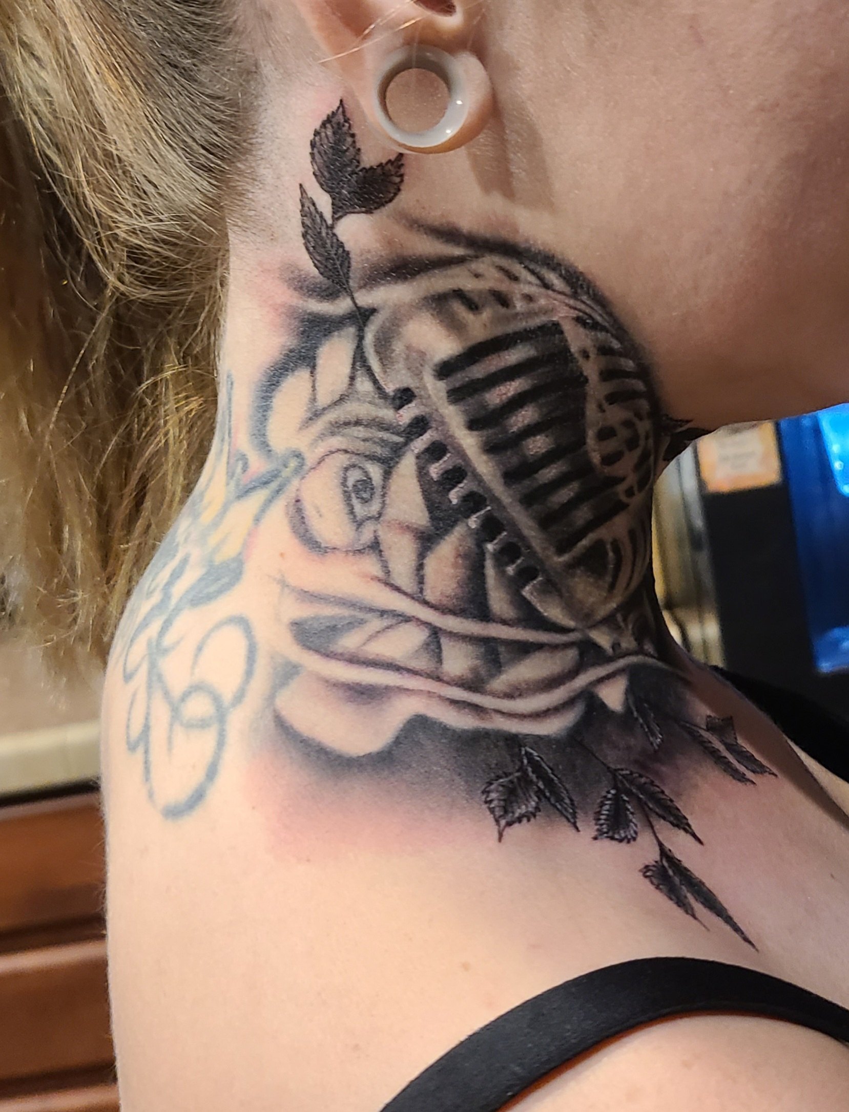Black and grey microphone neck tattoo by Social Suicide Tattoos in Pahrump, Nevada