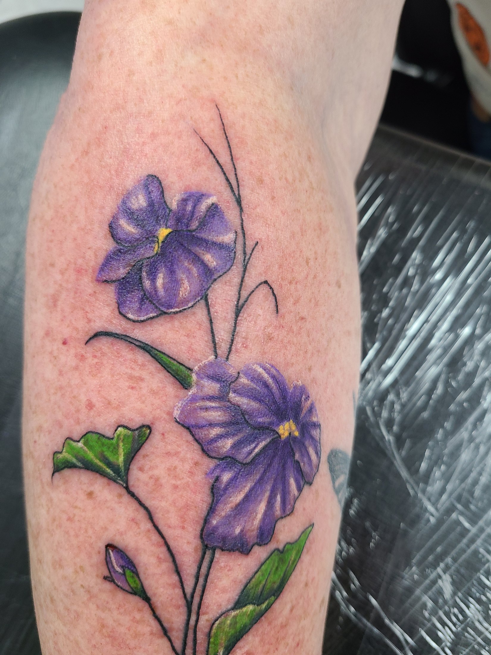 Purple flower color tattoo by Social Suicide Tattoos in Pahrump, Nevada