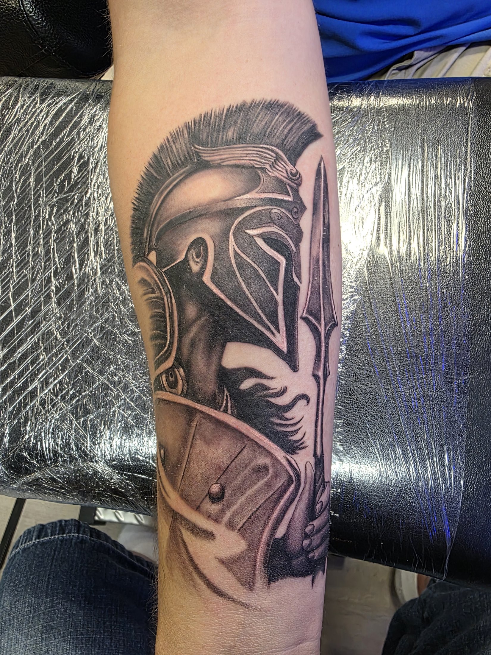 Black and grey helmet and spear tattoo by Social Suicide Tattoos in Pahrump, Nevada