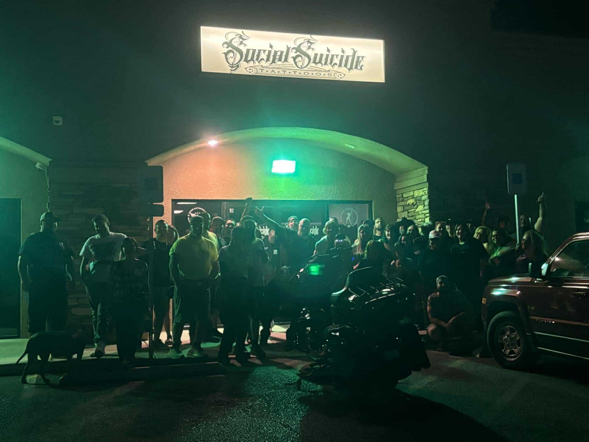 Social Suicide Tattoos storefront in Pahrump, Nevada at night with clients outside